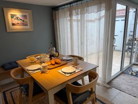 A dining room with a table set for breakfast at York Cottage in Southwold