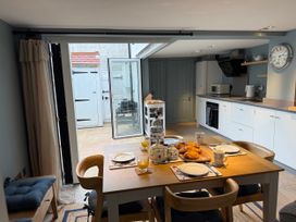 A kitchen with a dining table set for breakfast at York Cottage Southwold