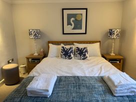 A bedroom with a bed and bedside tables at York Cottage Southwold