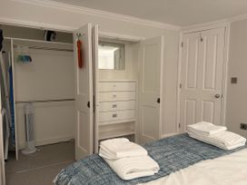 A bedroom with a bed and fitted wardrobe at York Cottage Southwold