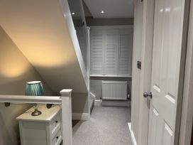 A landing area with a lamp and radiator at York Cottage in Southwold