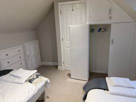 A bedroom with beds and storage furniture at York Cottage Southwold