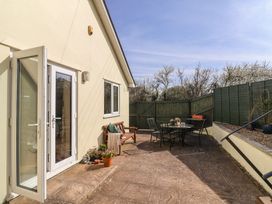 An outdoor area with a table and chairs at Regenna in Seaton