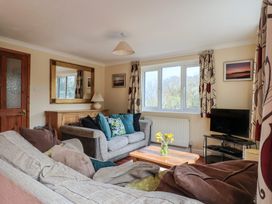A living room with a sofa and television at Regenna in Seaton