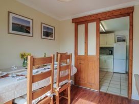 A dining room with a table set for dinner at Regenna in Seaton