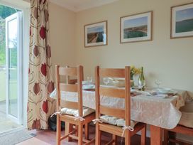 A dining room with a table set for meals at Regenna in Seaton