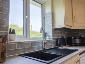 A kitchen with a sink and window at Regenna in Seaton
