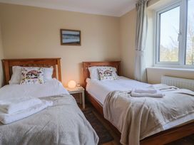 A bedroom with two beds and a window at Regenna in Seaton