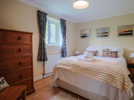 A bedroom with a bed and dresser at Regenna in Seaton