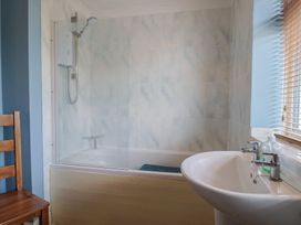 A bathroom with a shower and sink at Regenna in Seaton