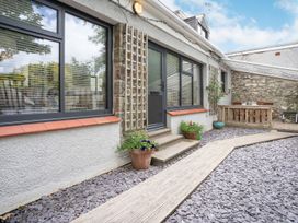 An outdoor area with windows and a door at Brewery Cottage