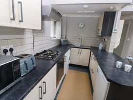 A kitchen with appliances including a microwave and toaster at Brewery Cottage