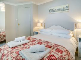 A bedroom with a bed and towels at Brewery Cottage 