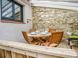 An outdoor dining area with a table and chairs at Brewery Cottage