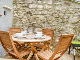 A dining table set with dishes and glasses at Brewery Cottage 