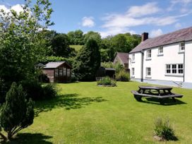 A garden with a picnic table and a shed at Picton House near St Clears