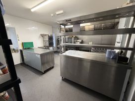 A kitchen with stainless steel appliances and counters at Picton House near St Clears