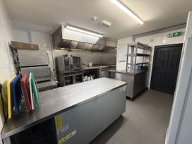A commercial kitchen with stainless steel appliances at Picton House near St Clears