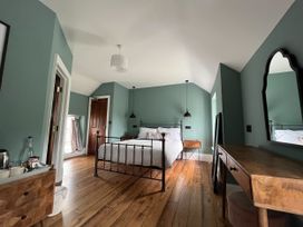 A bedroom with a bed and furniture at Picton House near St Clears