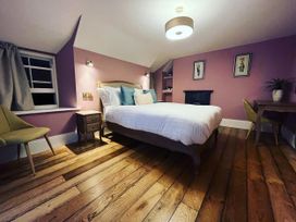 A bedroom with a bed and desk at Picton House near St Clears