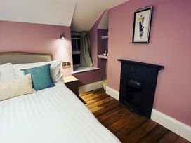 A bedroom with a bed and a fireplace at Picton House near St Clears