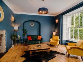 A living room with seating and a coffee table at Picton House near St Clears