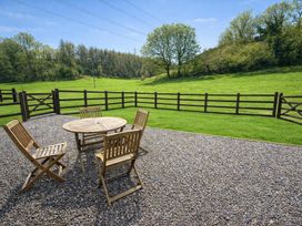 A table with chairs in a garden at Coach House St Clears