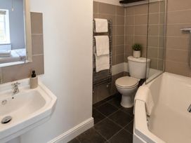 A bathroom with a sink, bathtub, and toilet at Coach House in St Clears