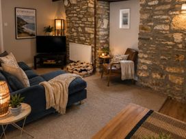 A living room with a television and sofa at Coach House in St Clears