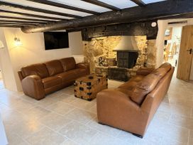 A living room with a sofa and coffee table at Bridge Cottage in Chideock