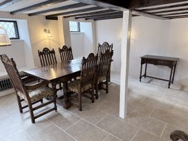 A dining room with a wooden table and chairs at Bridge Cottage in Chideock