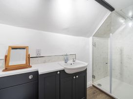 A bathroom with a sink and shower at Bridge Cottage in Chideock