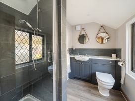 A bathroom with shower, sink, and toilet at Bridge Cottage in Chideock