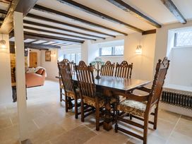 A dining room with a table and chairs at Bridge Cottage in Chideock