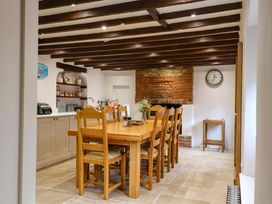 A kitchen with a dining table and chairs at Bridge Cottage, Chideock
