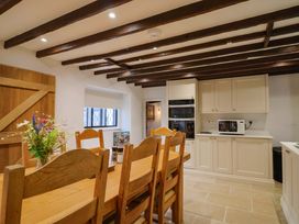 A kitchen with a dining table and chairs at Bridge Cottage in Chideock