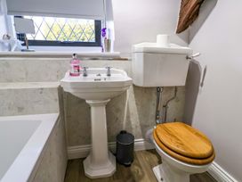 A bathroom with a sink and toilet at Bridge Cottage in Chideock