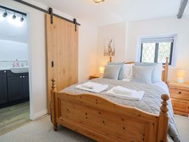A bedroom with a bed and bedside tables at Bridge Cottage in Chideock