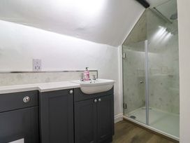 A bathroom with a sink and shower at Bridge Cottage in Chideock