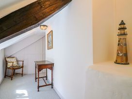 A landing with a table and a chair at Bridge Cottage in Chideock