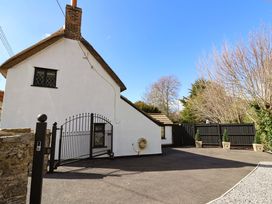 A house with a gate and driveway at Bridge Cottage in Chideock