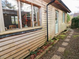 An exterior view of a wooden cabin with a pathway at Cabin in Newport