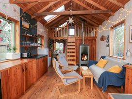 A living room with a stove and sofa at Cabin in Newport