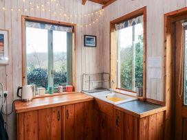A kitchen with a sink and kettle at Cabin in Newport