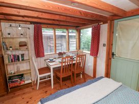 A dining area with a table and chairs at Cabin in Newport