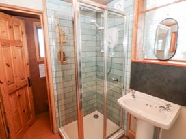A bathroom with a shower and sink at Cabin in Newport