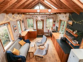 A living room with a sofa and kitchen at Cabin in Newport