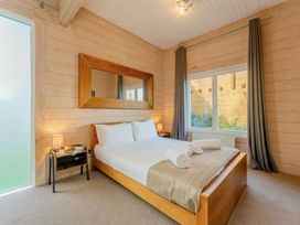 A bedroom with a bed and mirror at Poplar Lodge (Pet) Thirsk