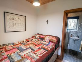 A bedroom with a bed and a sink at The Faithfuls Cabin in Dingle