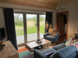 A living room with a sofa and armchair at The Faithfuls Cabin in Dingle, County Kerry